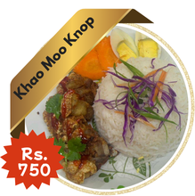 A savory plate of Khao Moo Krob (crispy pork belly with rice), featuring golden, crispy-skinned pork slices over steamed rice, served with a rich soy-based sauce and garnished with cucumber slices.