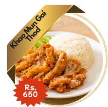 A delicious serving of Khao Man Gai Tod (Thai fried chicken rice) with crispy golden fried chicken over aromatic rice, served with cucumber slices, dipping sauce, and a side of clear soup.