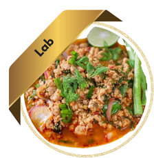 A bowl of Laab (Thai minced meat salad) garnished with fresh herbs, red onions, and lime, with a gold ribbon label reading "Lab."