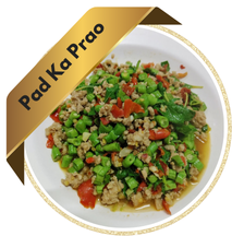 A sizzling plate of Pad Kra Pao (Thai basil stir-fry) with minced meat, chili, and holy basil,